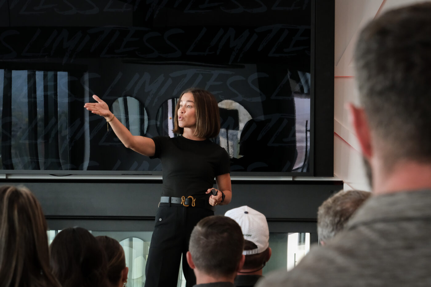 Tiffanie Janowitz speaking with presence in front of the Limitless Society backdrop